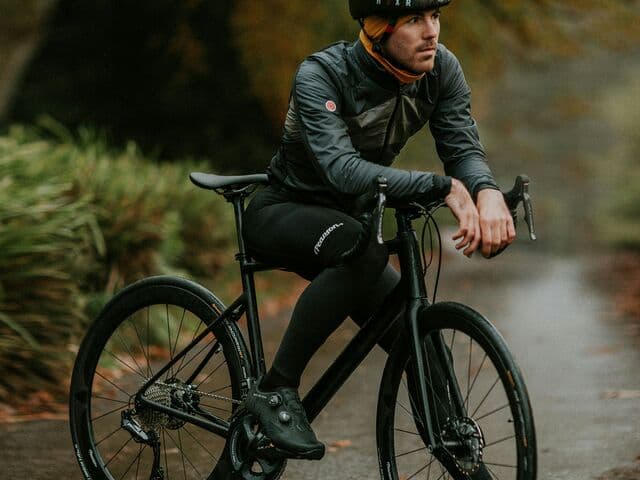 Cyclist resting on bike